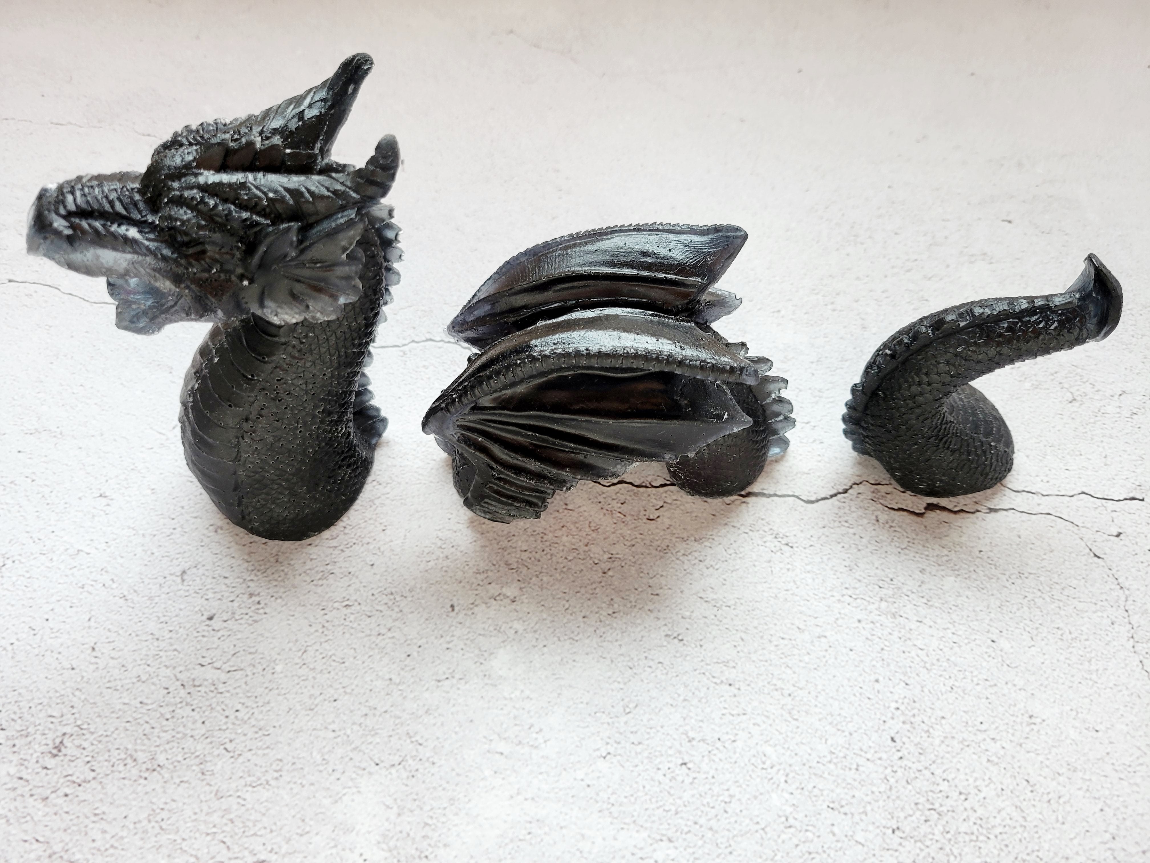 three piece resin sea serpent - Head, winged body, curved tail are all black. Top view