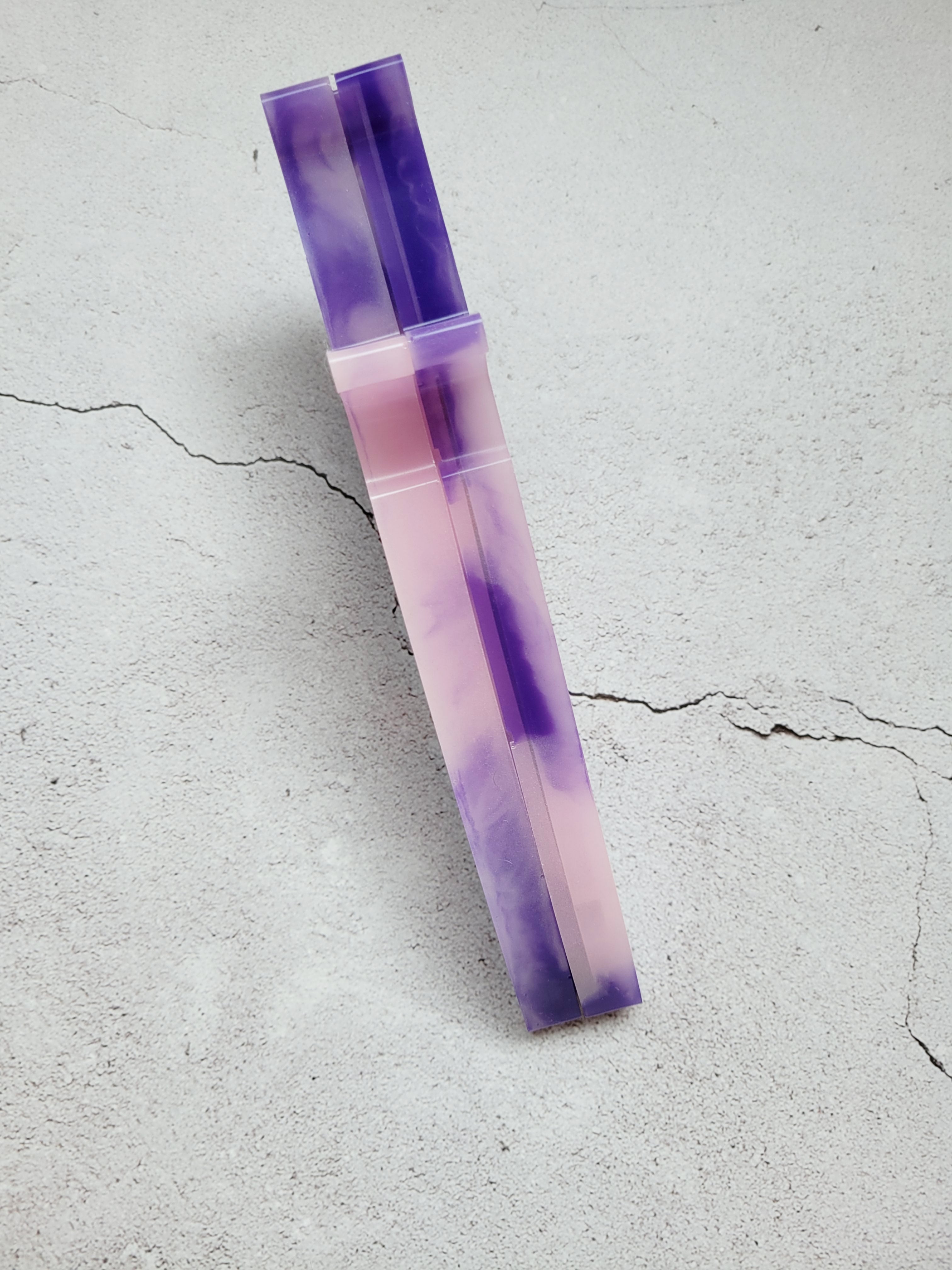 resin dice dagger. It's dark purple and light pink swirled together. Side view