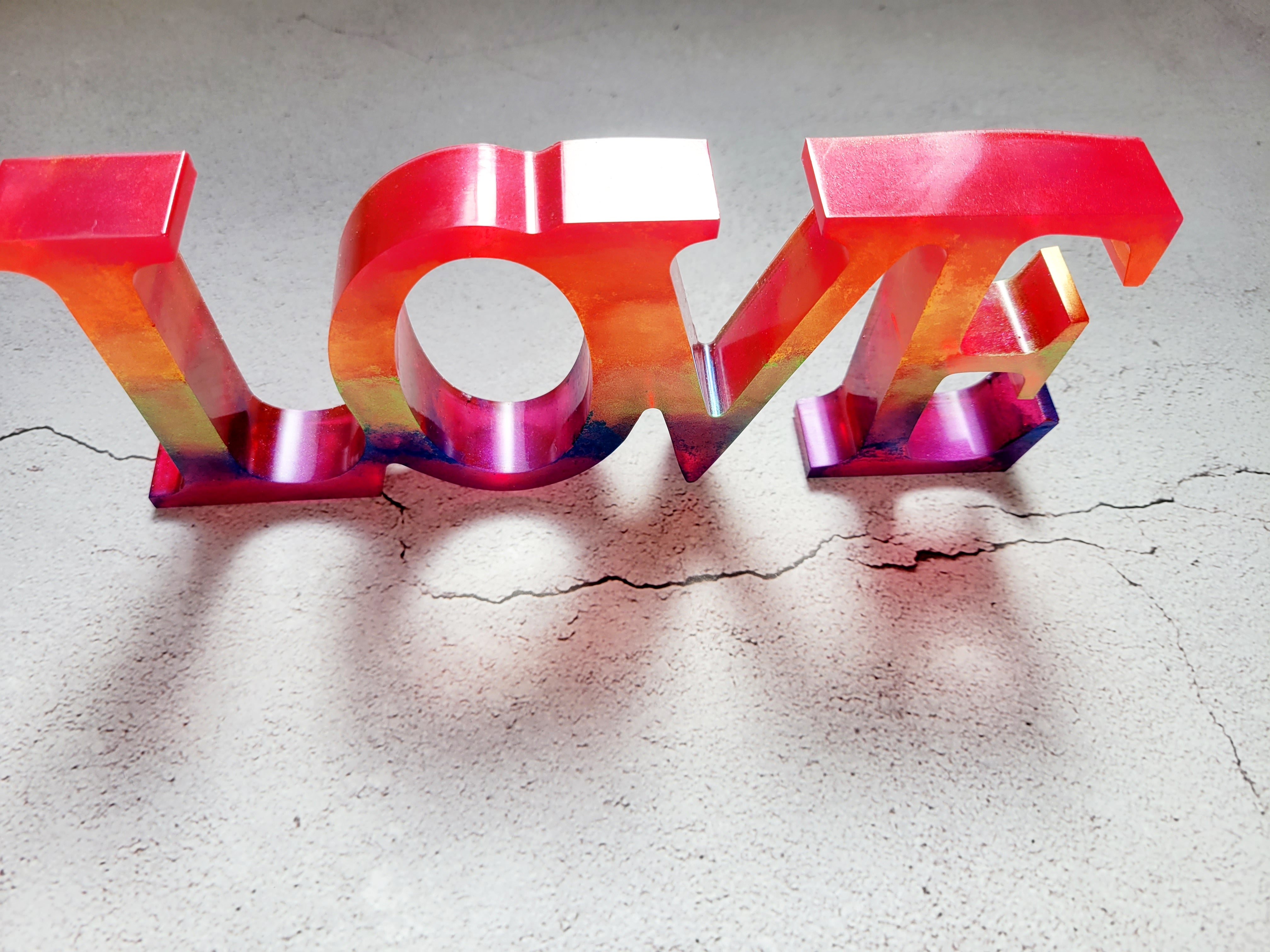 a resin made LOVE sign in pride rainbow colors